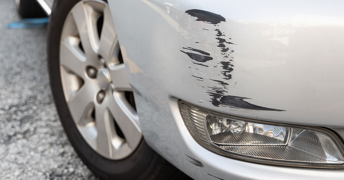 Close-up of a minor scratch on a car door covered by scratch and dent insurance